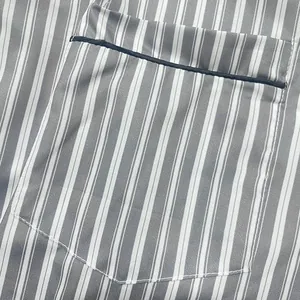 Detailed macro view of the chest pocket on a gray and white striped men's nightshirt robe
