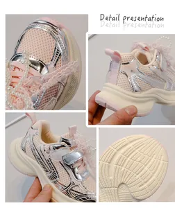 Detailed close-up view of pink girls' mesh sneakers with pearl and lace decorations.
