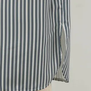 Detail shot of a men's striped sleep robe showing side slit and fine fabric texture