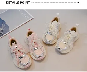 Close-up of girls' chunky sneakers with lace bows and pearl details for spring