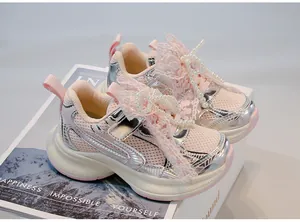 Detailed view of pink girls sneakers featuring elegant lace bows and pearl bead accents