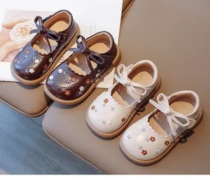 Detailed view of cute girls' Mary Jane shoes with floral embroidery and sweet bow-tie
