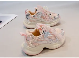 Close-up of pink girls' dad shoes featuring breathable mesh, lace bows, and pearls