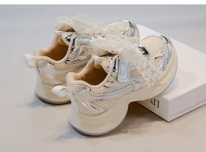 Detailed view of breathable girls' mesh sneakers with elegant pearl and lace decorations.