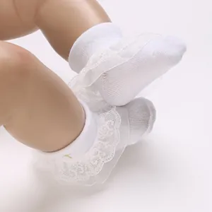 Elegant white infant socks featuring delicate lace ruffle details for babies aged 0-1 year old