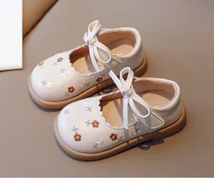 Toddler girl's Mary Jane shoes with floral embroidery and bow detail in beige.