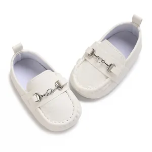 Vue détaillée des mocassins en cuir blanc pour bébé avec boucle mors argentée.