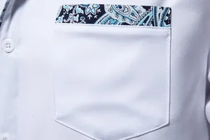 Macro detail showing the chest pocket of a men's white shirt with blue paisley pattern