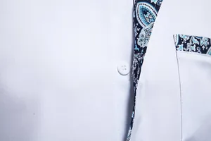 Detail of men's casual white shirt with blue paisley pattern on collar and pocket
