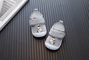 Close-up of grey cartoon baby walking shoes with anti-kick toe and velcro strap