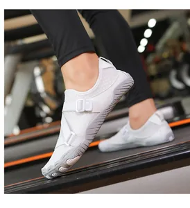 Detail view of white non-slip barefoot water shoes being worn for fitness on a treadmill.