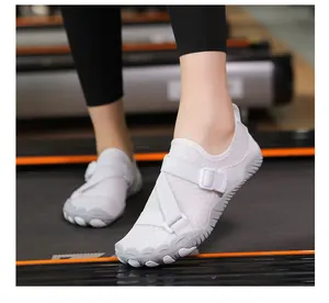 Close-up view of breathable white mesh water shoes with straps worn on a gym treadmill