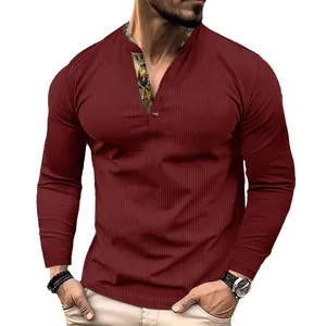 Detail of burgundy waffle knit men's long sleeve polo shirt with patterned placket