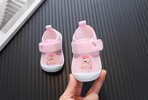 Close-up detail of pink cartoon unicorn baby walking shoes with anti-kick rubber toe caps