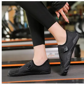 Detailed view of black quick-dry water shoes on a treadmill for fitness and outdoor use