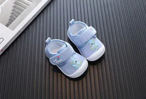 Detailed close-up of blue cartoon baby squeaky walking shoes with elephant patch