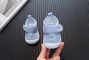 Detailed view of blue cartoon baby walking shoes with adjustable velcro strap detail