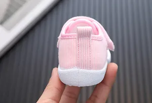 Detailed view of pink baby walking shoe heel showing fabric texture and sole