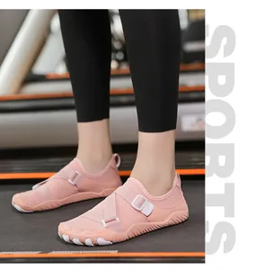 Macro view of pink aqua shoes with adjustable cross straps for fitness and swimming.