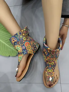 Detail of ethnic floral print flat sandals with high ankle wrap and thong design