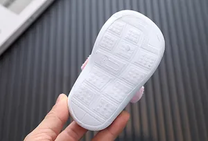Macro detail view of the durable non-slip white rubber sole for infant walking shoes