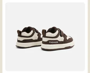Vista posterior detallada de zapatillas de bebé marrón y crema con texto FASHION