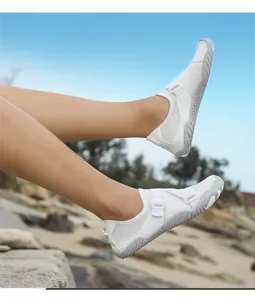 Action shot showing the breathable white mesh and grey non-slip sole of these water shoes.