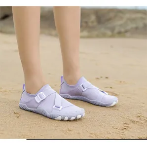 Light purple outdoor wading shoes for swimming and snorkeling on a sunny sandy beach