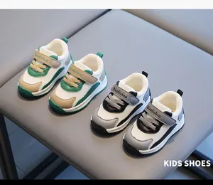 Breathable mesh toddler walking shoes in green and grey color options on a chair