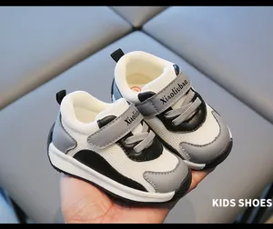 Close-up detail of breathable mesh baby walking sneakers in grey and white color