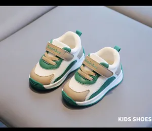 Detailed close-up of breathable mesh baby sneakers in green and beige with velcro.