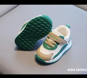 Detailed macro view of breathable green and white toddler mesh sneakers with soft rubber soles