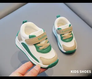 Close-up of green and white breathable mesh toddler sneakers with velcro strap