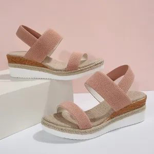 Detail van roze plateauzolen sleehak met elastische bandjes en geweven textuur