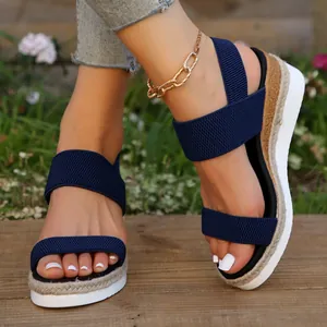 Detailopname van marineblauwe sleehaksandalen met elastische band en plateauzool