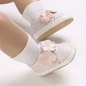Gros plan de chaussures souples pour bébé roses avec paillettes et fleurs