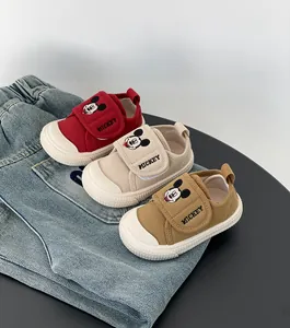 Tre paia di scarpe primi passi in tela morbida per bambini nei colori rosso e beige.