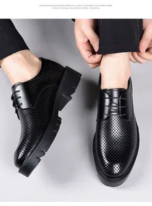 Close-up of black perforated men's elevated dress shoes with thick soles