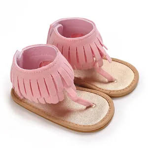 Macro detail of pink baby thong sandals with stylish fringe and soft glittery sole