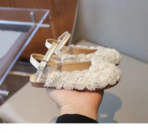 Detail view of girls' white floral lace sandals with adjustable strap closure