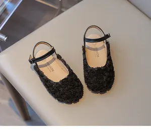 Close-up of elegant black girls' 3D rose flower closed-toe sandals with buckle strap