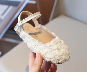 Detail of white floral appliques on girls' elegant closed-toe princess sandals