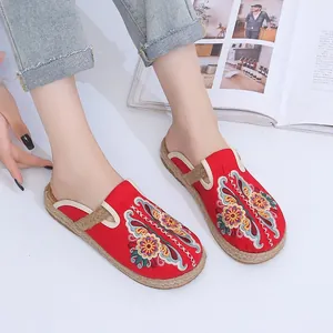 Elegant red ethnic embroidered slippers with traditional floral patterns and woven soles