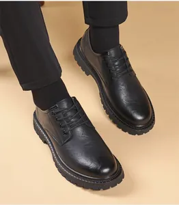 Detailed view of black men's platform work shoes being worn showing lug sole texture