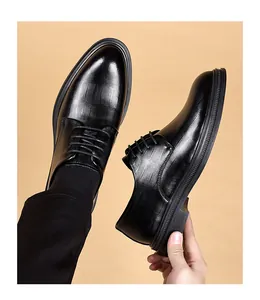Detailed view of black textured leather business dress shoes for men featuring lace-up design
