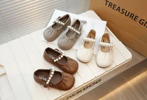 Detailed view of children's Mary Jane shoes featuring pearl straps in three earthy colors.