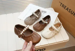 Vintage girls Mary Jane shoes featuring pearl straps and bow details in multiple colors.