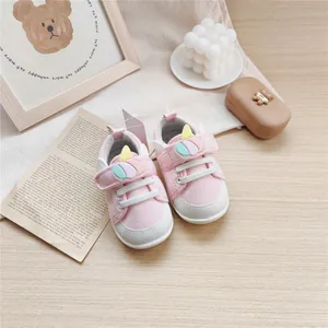 Detailed view of pink cartoon baby walking shoes featuring soft soles and cute unicorn decor