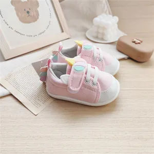 Cute pink baby walking shoes with soft soles and cartoon unicorn decorations for infants.