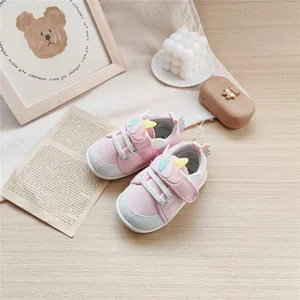 Pink baby walking shoes with soft rubber soles and cute cartoon unicorn wing design.